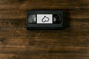 A VHS tape with a label featuring a stylized heart drawing sits on a wooden surface. Where is the Last Blockbuster? Things to do in Bend Oregon